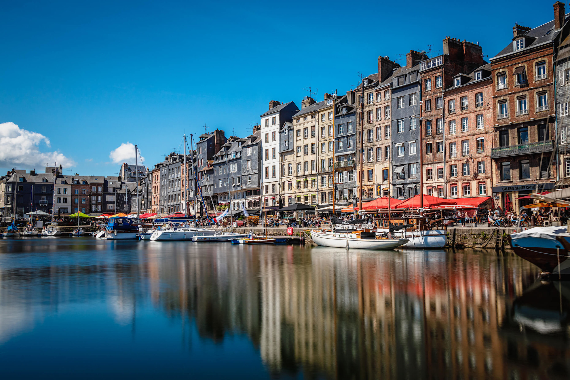 Colourful half-timbered houses jostle for position on the quays in Honfleur