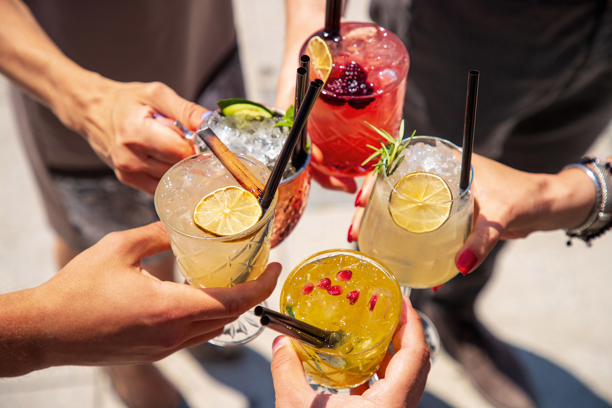 Cocktails in hands joined in celebratory toast